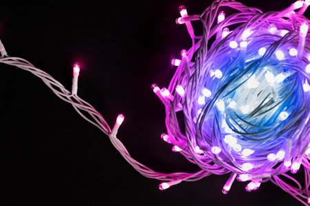 Pink and blue flash lights garland on dark background