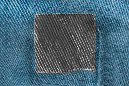 Empty black patch on blue fabric as a backgroundの写真素材