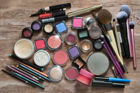 Collection of makeup products and brushes on wood backgroundの写真素材
