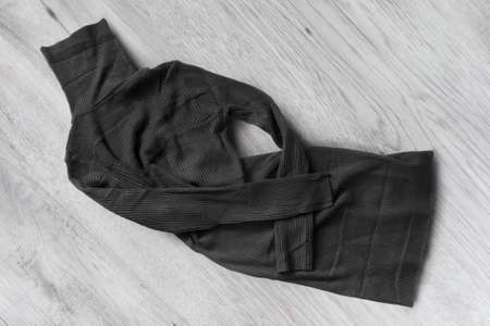 Wrinkled black mini dress on white wood backgroundの写真素材