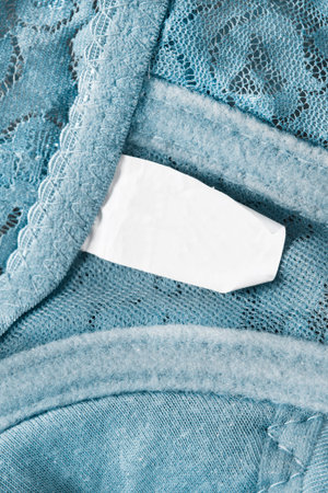 Empty clothing label on blue lace background