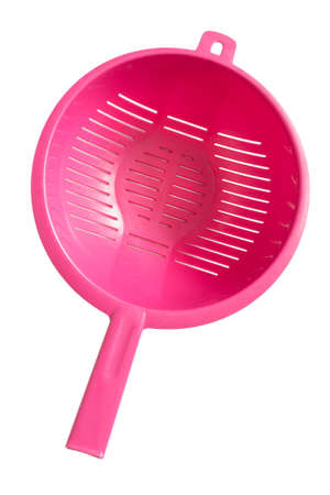 Pink plastic colander isolated on white backgroundの写真素材