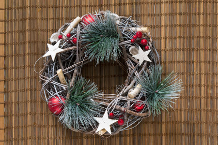 Decorative christmas wreath on bamboo mat backgroundの写真素材