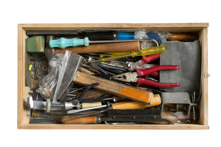 Old hand tools in a box isolated on white background
