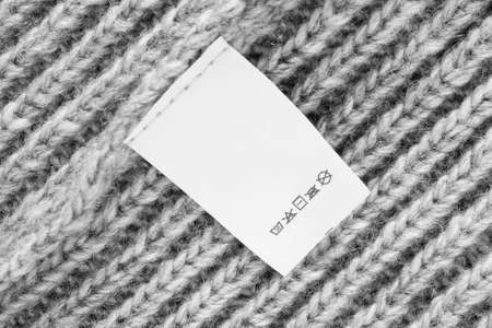 Care instructions clothing label on gray knit backgroundの写真素材