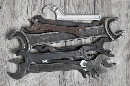 Old Russian double ended spanners on wood background
