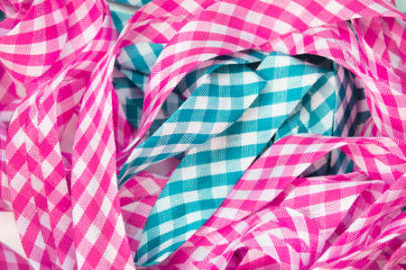 Pink and cyan checkered laces closeup as a backgroundの写真素材