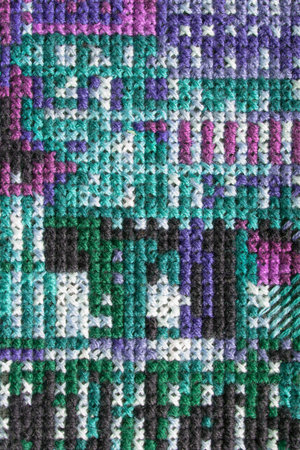 Abstract colorful cross stitch embroidery closeup as a background
