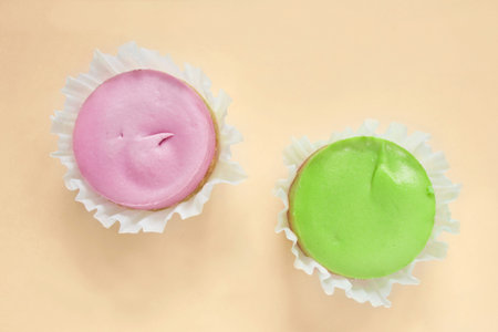 Pink and green wrapped cakes on yellow background