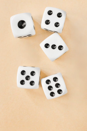 Five rolled six sided dice on yellow backgroundの写真素材