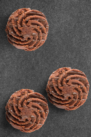 Three chocolate cakes on back backgroundの写真素材