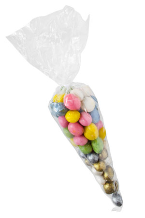 Colorful dragee candies in plastic pack isolated on white background