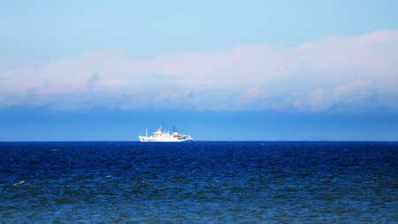 White ship sailing on the skyline on the seaの写真素材