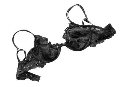 Black lacy unfastened brassiere isolated on white backgroundの写真素材