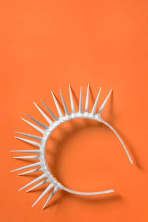 Plastic thorn hair band crown on orange backgroundの写真素材