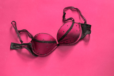 Elegant pink and black push up bra on magenta pink backgroundの写真素材