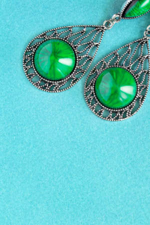 Vintage silver malachite earrings closeup on blue backgroundの写真素材