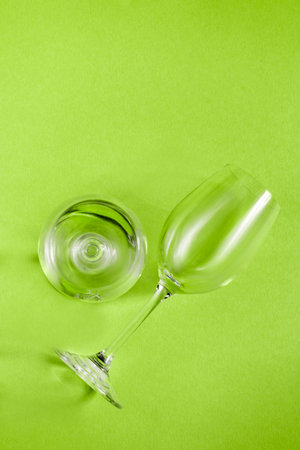 Two clean empty wineglasses on green backgroundの写真素材