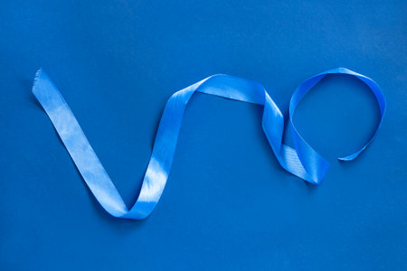 Blue wrapping ribbon on blue backgroundの写真素材