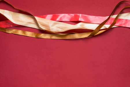 Satin wrapping ribbons on red backgroundの写真素材
