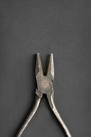 Old steel hand pliers closeup on black backgroundの写真素材