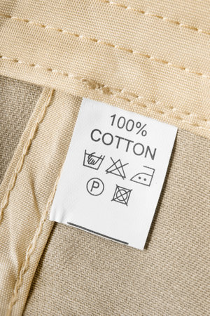 Fabric composition and care instructions clothing label on beige back side fabricの写真素材