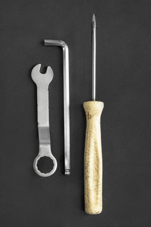 Set of hand tools: wrench and screwdrivers on black background