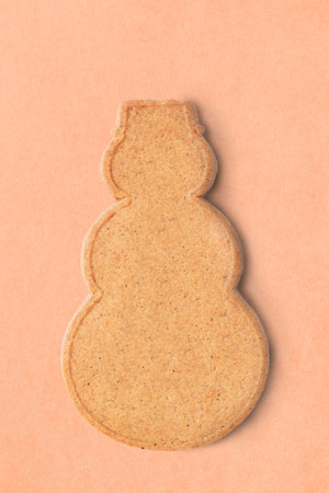 Gingerbread in the shape of snowman on beige backgroundの写真素材