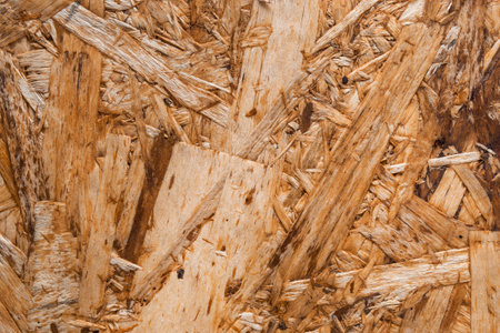 Yellow chipboard texture closeup as a background