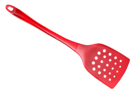 Red plastic cooking spatula isolated on white backgroundの写真素材