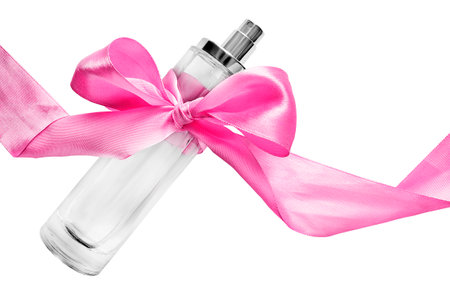 Glass perfumery bottle tied pink ribbon bow isolated on white backgroundの写真素材