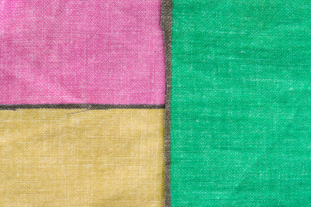 Pink, green and yellow fabric patches closeup as a backgroundの写真素材