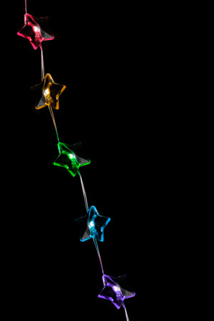 Colorful star shaped led lights garland isolated on black background