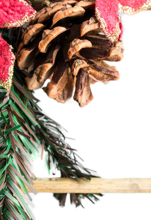 Christmas decorations with natural fir tree cone isolated on white background closeupの写真素材