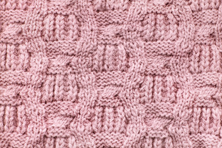 Pink wool knit texture close up as a background