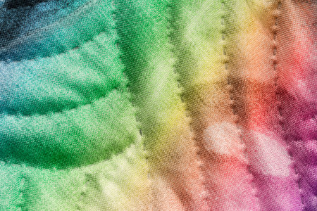 Abstract rainbow color stitched fabric closeup as a background