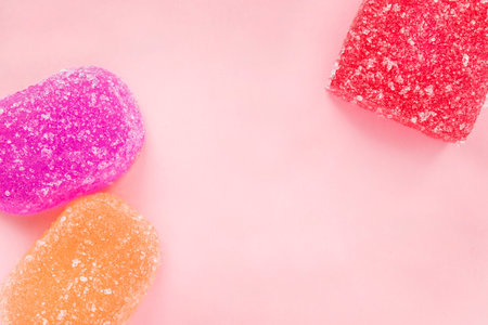 Colorfuln fruit jelly candies on pink studio backgroundの写真素材