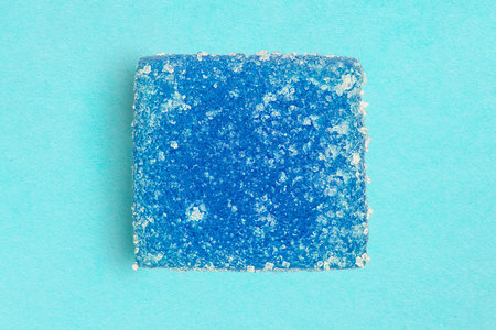 Blue sugar jelly candy on light blue studio backgroundの写真素材