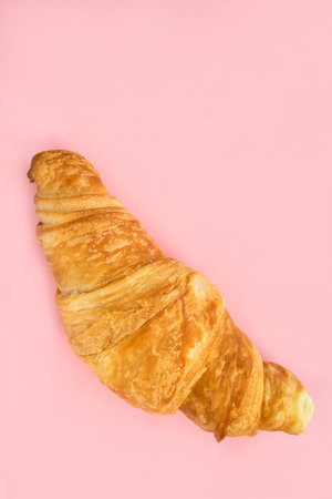 Fresh baked french croissant on pink studio backgroundの写真素材