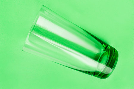 Green empty glass on green studio backgroundの写真素材