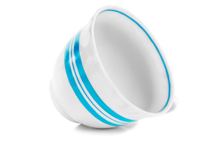Empty white blue strips ceramic cup lying on white backgroundの写真素材