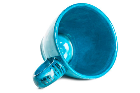 Empty blue ceramic tea cup isolated on white backgroundの写真素材