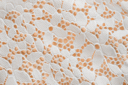 White crochet cotton lace closeup on yellow background
