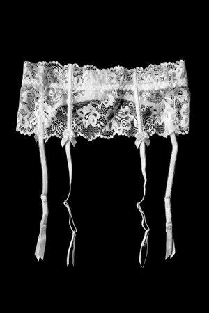 White lingerie stocking belt isolated on black backgroundの写真素材