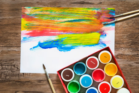 Colorful abstract gouache drawings and paints on wooden backgroundの写真素材
