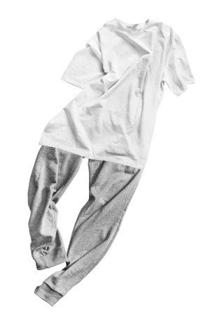 Oversized white t-shirt and gray pants outfit isolated on white backgroundの写真素材