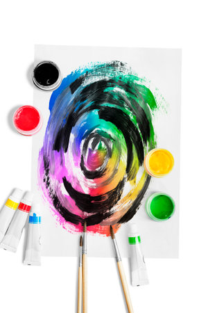 Colorful abstract blending drawing, paint jars and brushes isolated over whiteの写真素材