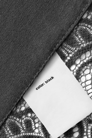 Clothes label cays color black on fabric background closeupの写真素材