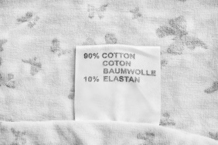 Fabric composition clothes label on white fabric as a background closeupの写真素材
