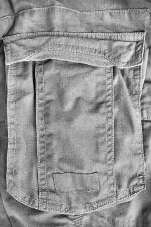 Gray cotton cargo pants flap patch pocket closeup as a backgroundの写真素材